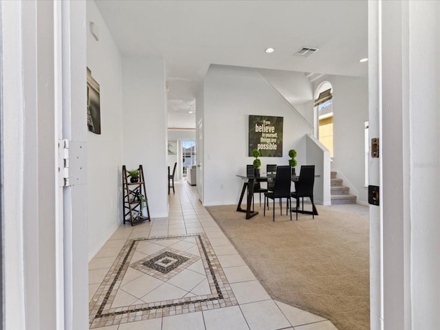 hall featuring light colored carpet