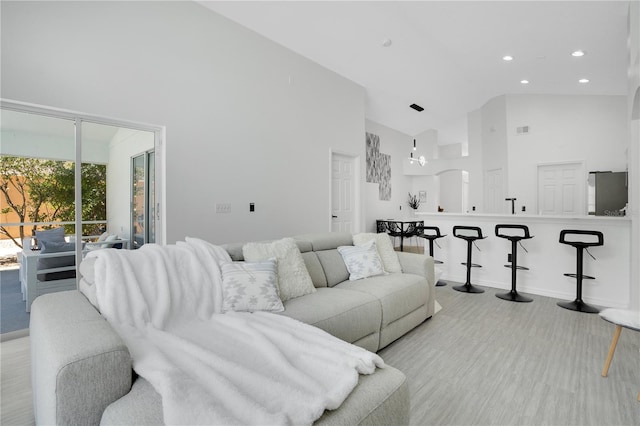 living room featuring high vaulted ceiling