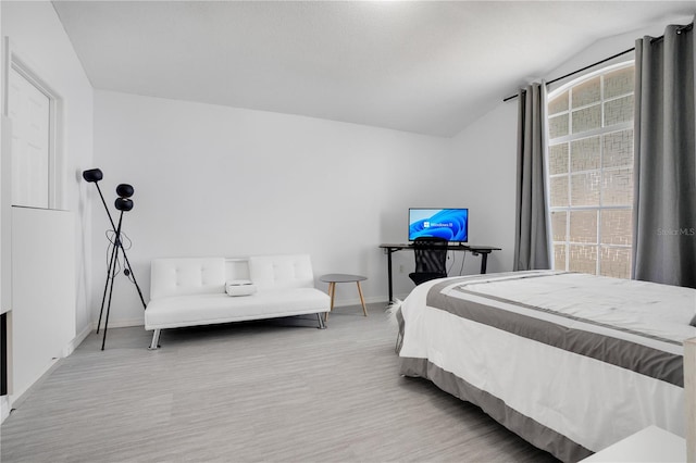 carpeted bedroom with lofted ceiling