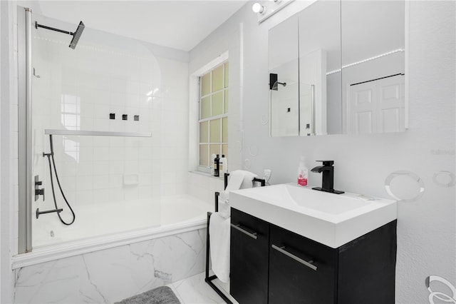 bathroom featuring vanity and tiled shower / bath combo