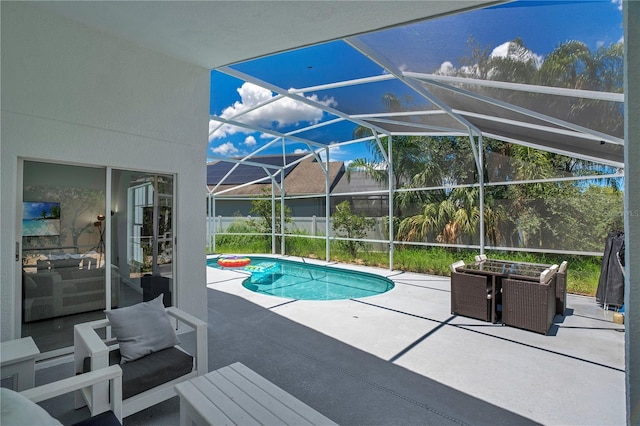 view of swimming pool with a patio and glass enclosure