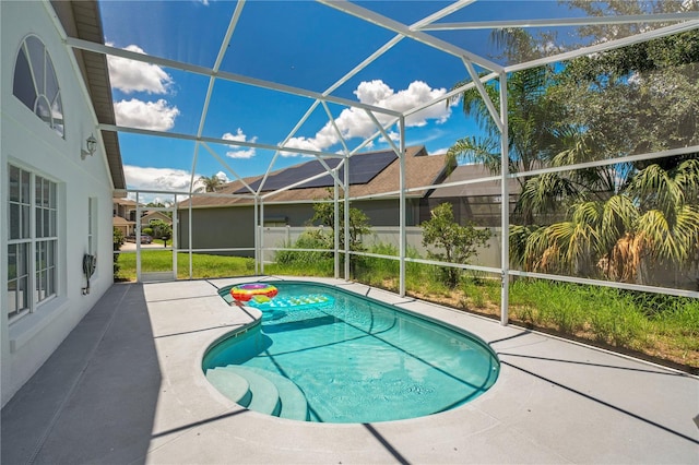 view of swimming pool with a patio and a lanai