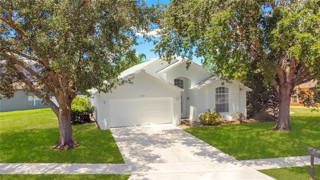 view of front facade with a front yard and a garage