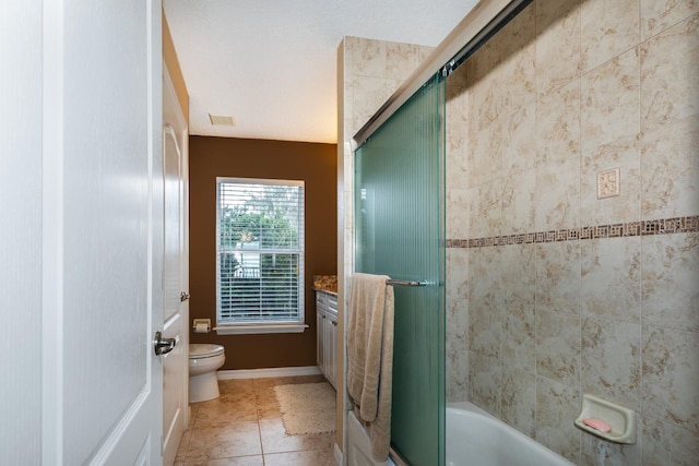 full bathroom with tile patterned flooring, vanity, toilet, and shower / bath combination with glass door