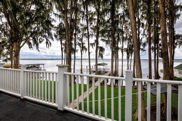 balcony featuring a boat dock and a water view