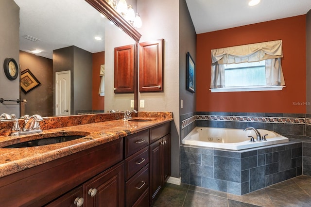 bathroom with vanity, a relaxing tiled tub, and tile patterned floors