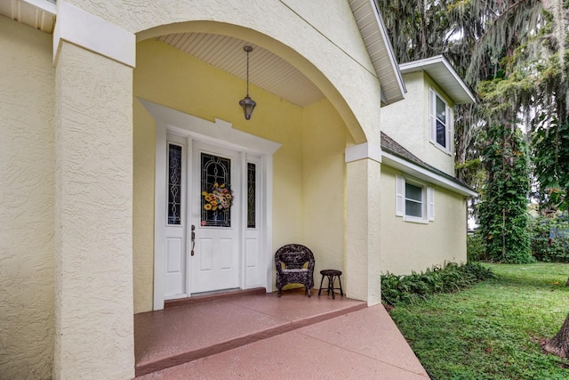 entrance to property with a yard