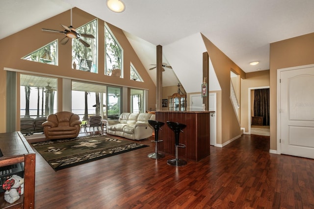 living room featuring dark hardwood / wood-style flooring and high vaulted ceiling