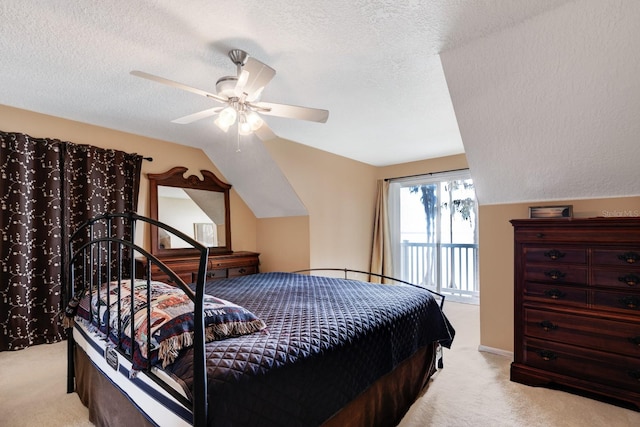 bedroom with a textured ceiling, ceiling fan, light carpet, and lofted ceiling