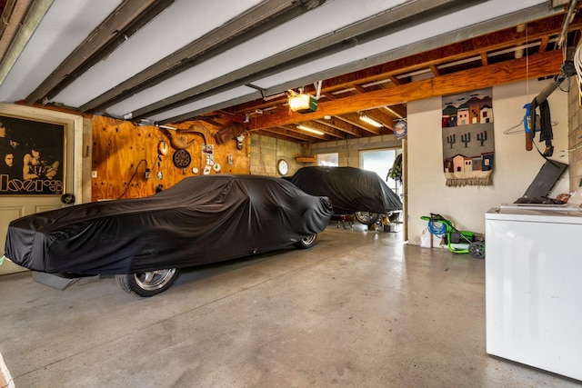 garage with a garage door opener and washer / dryer