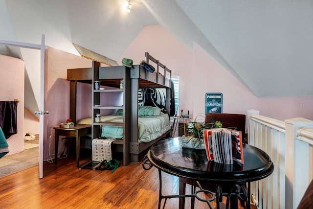 bedroom featuring vaulted ceiling and hardwood / wood-style flooring