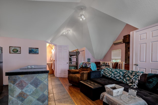 tiled bedroom with vaulted ceiling and a wall mounted AC