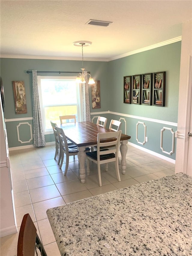 tiled dining space with ornamental molding and a notable chandelier