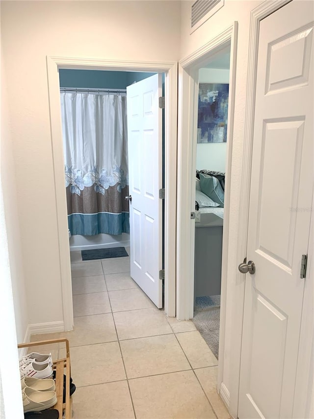 corridor with light tile patterned floors