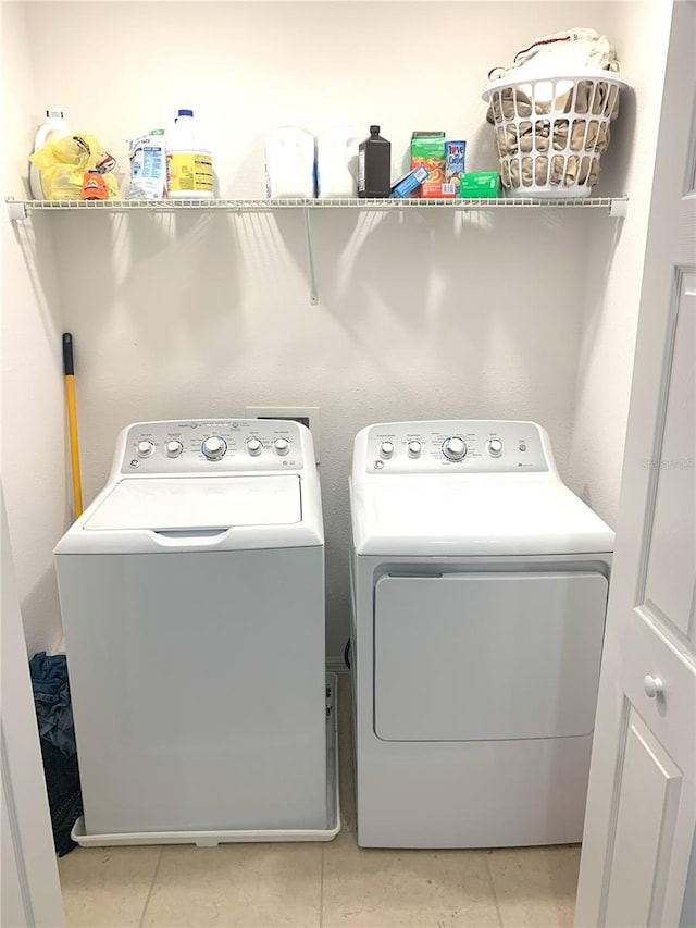 washroom featuring light tile patterned floors and separate washer and dryer