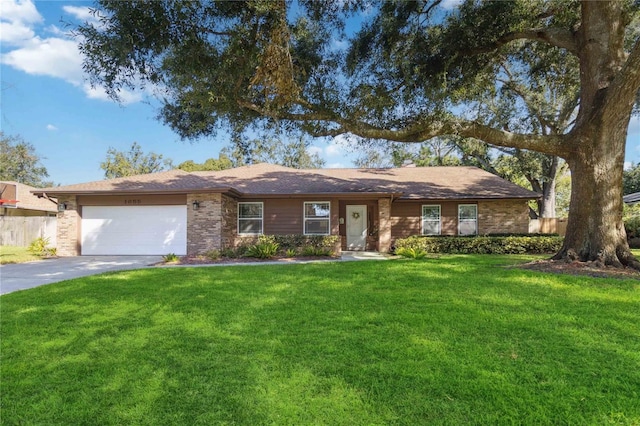 ranch-style house featuring a front yard and a garage