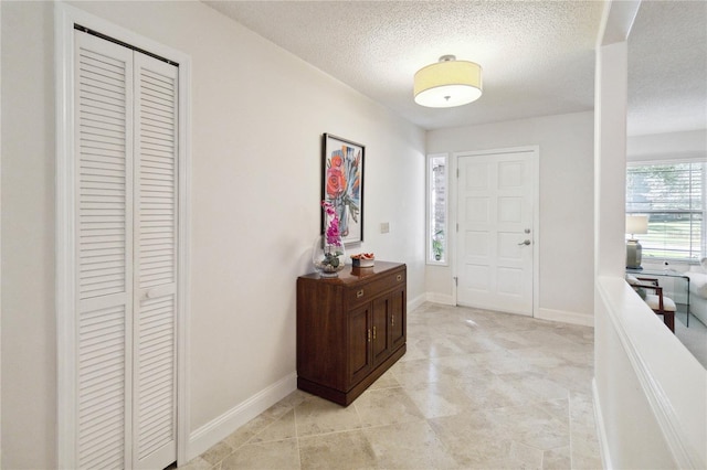 foyer entrance featuring a textured ceiling