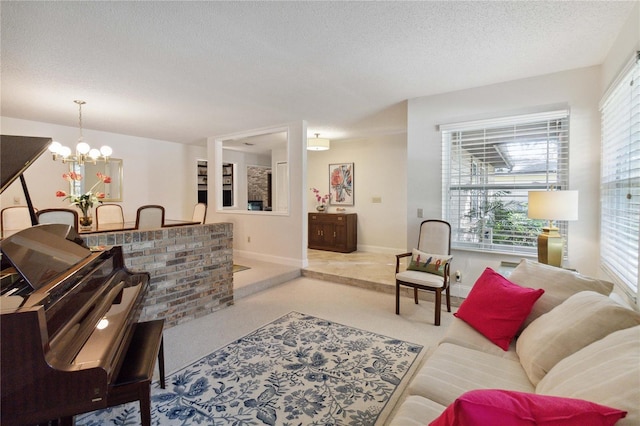 living room with a notable chandelier, a textured ceiling, and a wealth of natural light