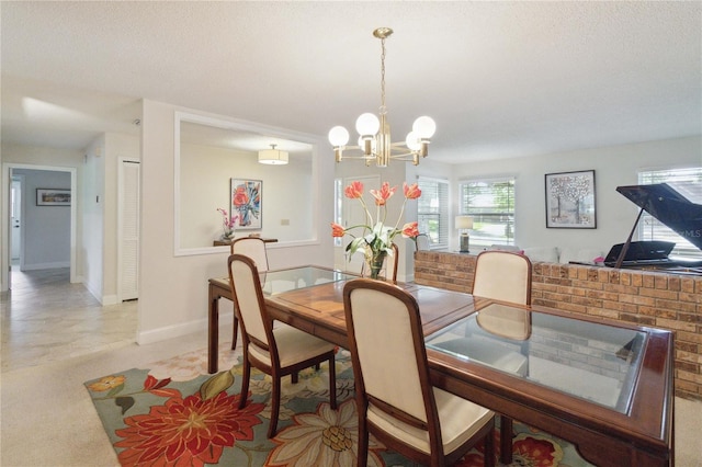 dining space featuring a textured ceiling and a chandelier