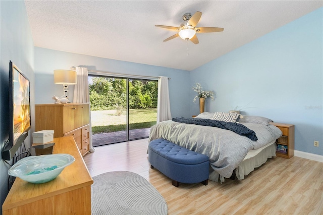 bedroom featuring ceiling fan, light hardwood / wood-style flooring, and access to exterior