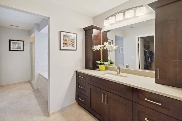 bathroom featuring vanity, independent shower and bath, and tile patterned flooring