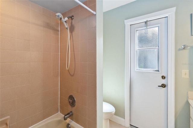 bathroom featuring toilet and tiled shower / bath combo