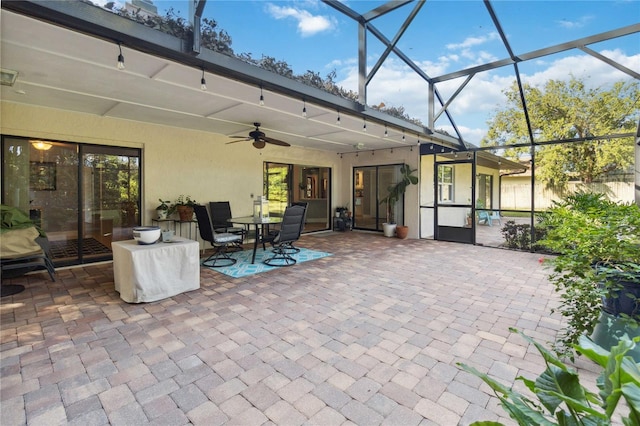 view of patio featuring a lanai and ceiling fan