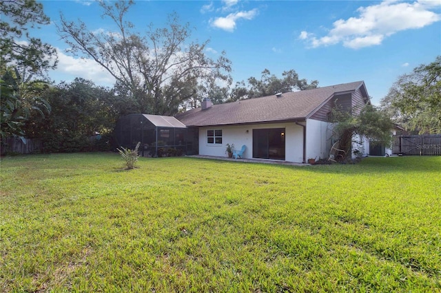 rear view of house with a lawn