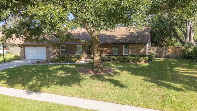 view of front of home with a front yard and a garage