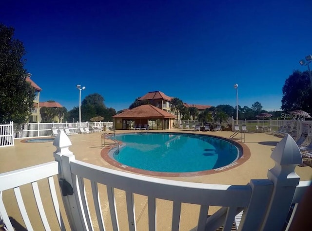 view of swimming pool with a gazebo and a patio area