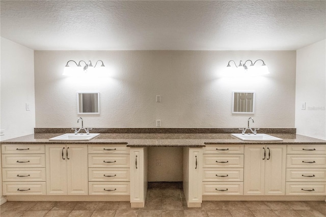 bathroom with vanity and a textured ceiling