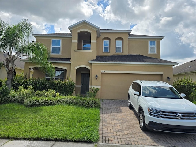 view of front facade featuring a front lawn and a garage