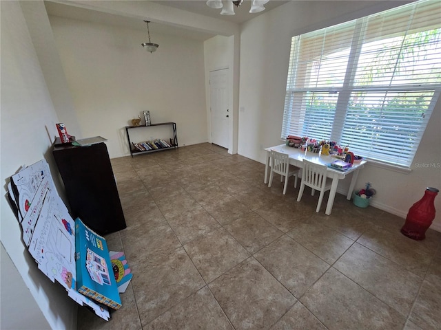 interior space featuring a notable chandelier and tile patterned flooring