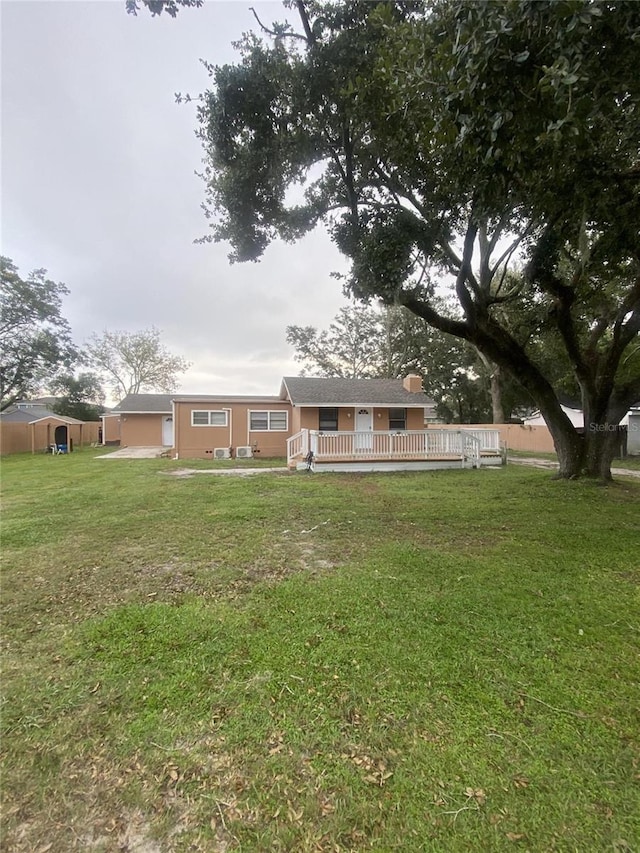 1801 Daniels St, Kissimmee, FL 34746 - rear view of property featuring a wooden deck and a yard