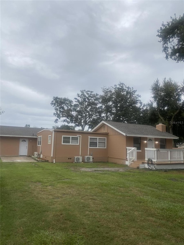 rear view of property featuring a yard and a garage