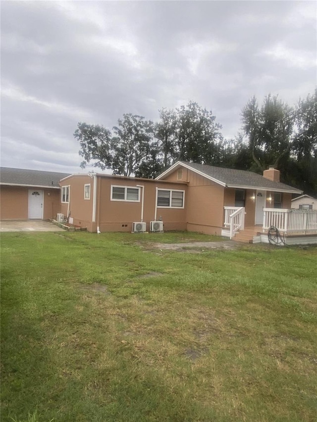 exterior space with central AC, a yard, and a garage