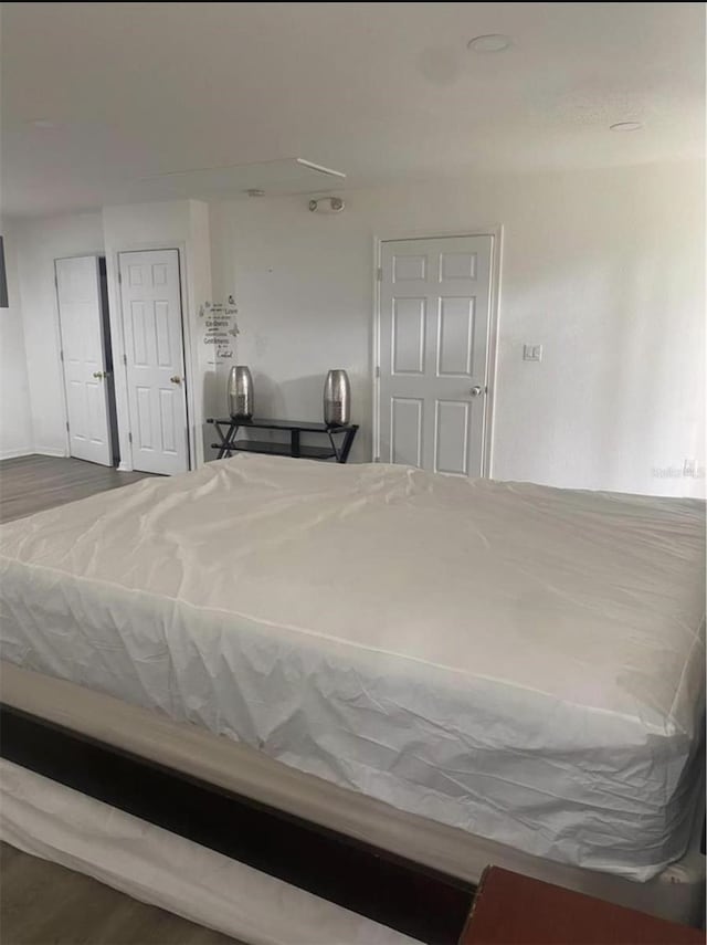 unfurnished bedroom with hardwood / wood-style flooring