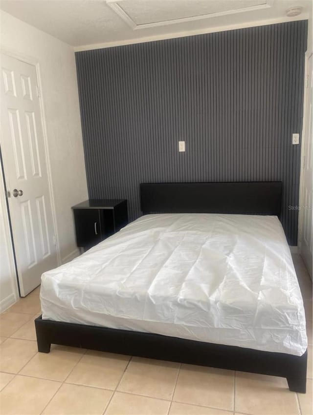 bedroom with light tile patterned floors