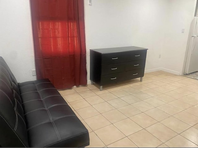 1801 Daniels St, Kissimmee, FL 34746 - bedroom with freestanding refrigerator, light tile patterned floors, and baseboards