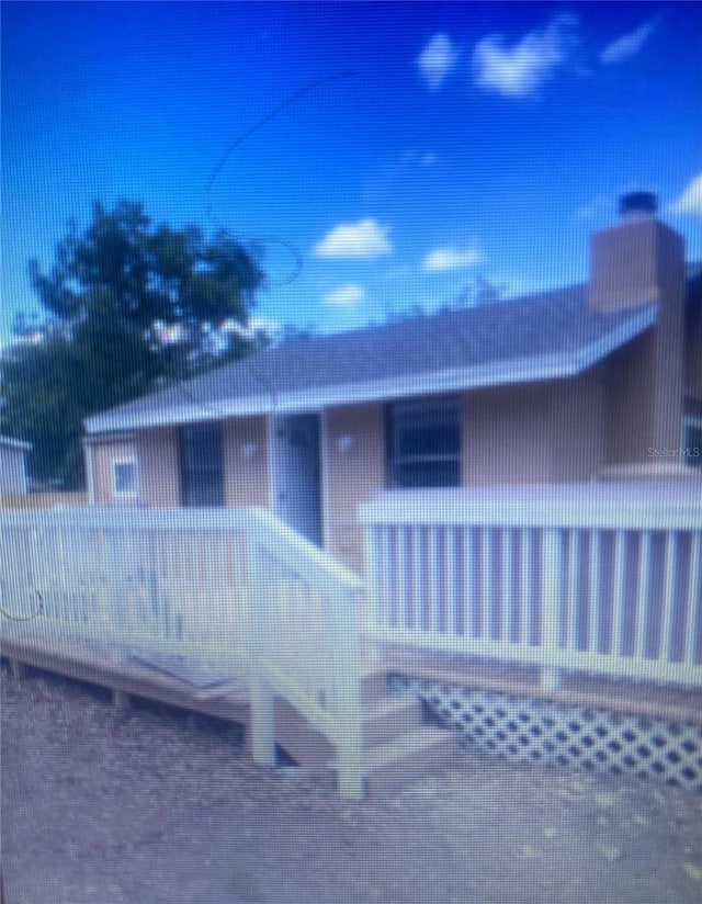 1801 Daniels St, Kissimmee, FL 34746 - rear view of property featuring a chimney