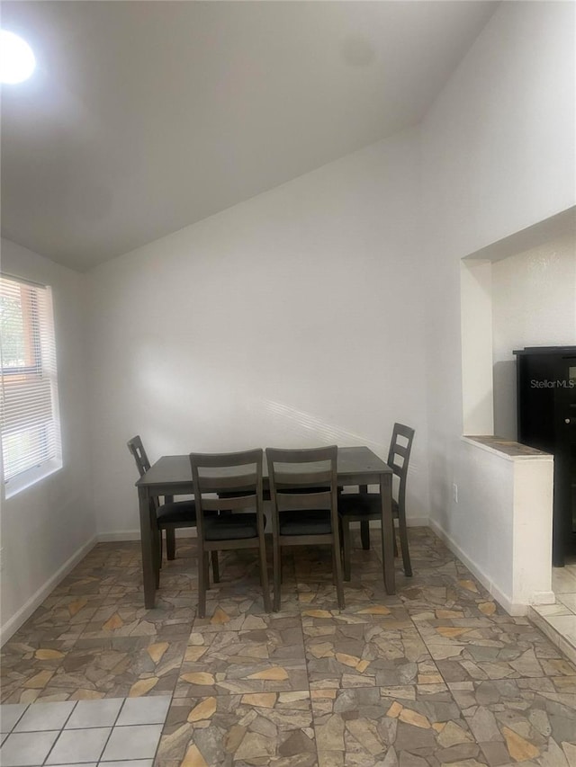 dining space featuring lofted ceiling