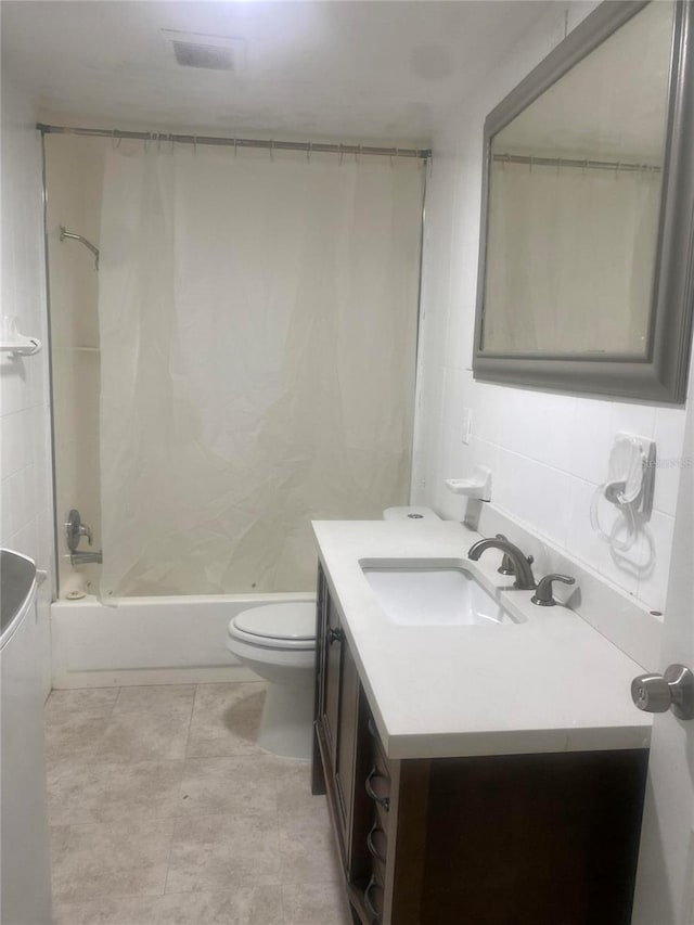 full bathroom with backsplash, toilet, shower / bath combo, vanity, and tile patterned flooring