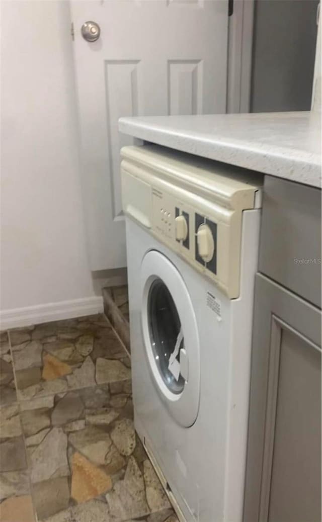 clothes washing area with washer / dryer