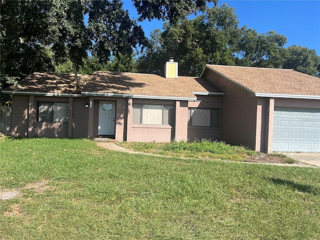 ranch-style home with a front yard and a garage