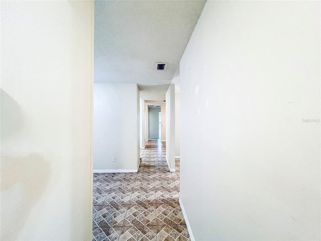 hall with a textured ceiling