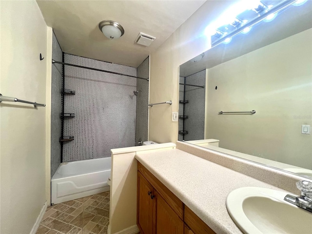 bathroom with vanity and tiled shower / bath combo