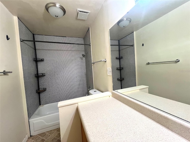 bathroom with vanity and tiled shower / bath combo