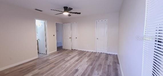 unfurnished bedroom with baseboards, ceiling fan, and wood finished floors