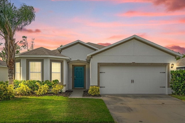 view of front of home featuring a yard and a garage