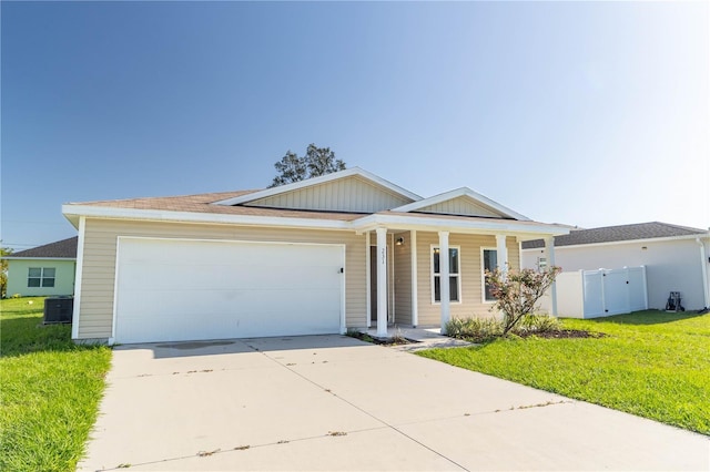 ranch-style house featuring a front yard and a garage